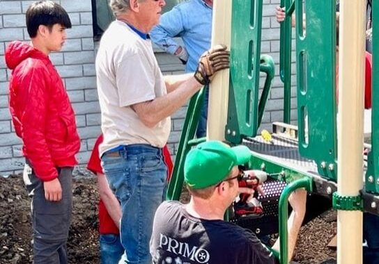 Successful playground assembly with volunteers.
